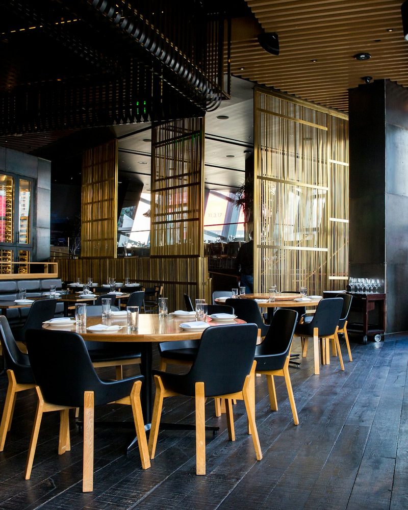 Restaurant dining room with coordinated seating, tables, and place settings