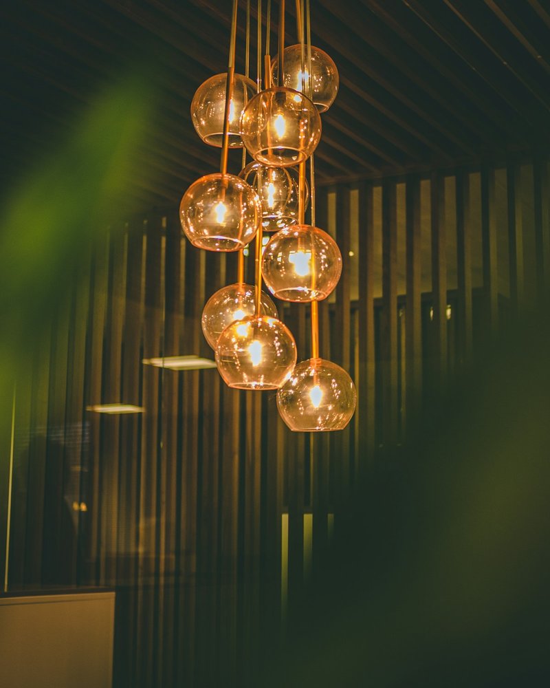 Feature chandelier and coordinated lighting in a hospitality space